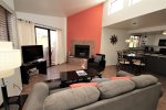 Living room with decorative fireplace and patio access