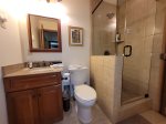 Bathroom located on the lower level with stand up glass shower - serves bunk room level 