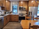 New stainless steel appliances including dishwasher, microwave, coffee maker, and toaster oven 
