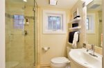 2 person shower with 2 shower heads, tumbled marble.  Tommy Bahama bath amenities