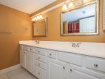 The private master bathroom offers a large vanity