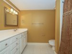 The guest bathroom has a large vanity and shower/tub combo in 1839 Beachside Tennis