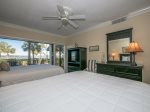 Guest Bedroom with TV Offers Water Views and Deck Access at 1848 Beachside Tennis