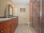 Renovated Guest Bathroom with Double Vanity and Walk In Shower at 1848 Beachside Tennis
