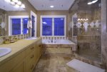 Double vanity, soaking tub, and walk-in shower in the master bathroom