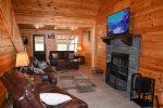 Living Area with Wood Burning Fireplace and 55-inch TV