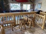 Log Slab bar with stools looking into the living room from the dining area.