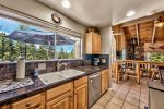 Upstairs Kitchen: looking out to upper deck, and convenience to the dining area