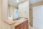 Bathroom featuring a shower, sink with vanity, granite countertops, a washer and dryer and a closet for additional storage