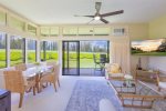 The living area offers a pullout sofa bed, a cozy seating arrangement with a couch, chairs, a coffee table and a flat screen TV