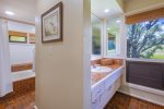 The spacious bathroom offers dual vanities 