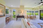 The bright and airy living room features wrap-around windows that invite Mauis natural surroundings indoors