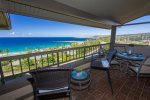 Furnished with a dining set and two chaise lounges, the lanai provides a serene retreat for al fresco meals or quiet relaxation