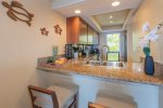 A breakfast bar with seating for two offers a relaxed space for morning coffee or a quick bite