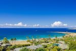 The large wrap-around windows frame sweeping views of the ocean and coastline, reaching all the way to world-famous Honolua Bay