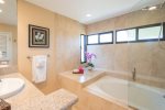 Guests can enjoy dual vanities, granite countertops, an oversized soaking tub with shower, and the added convenience of a washer and dryer