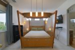 The master bedroom has a queen bed and adjoining bathroom
