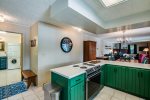 Kitchen with the half bath to the left and the dining area/living room to the right