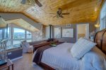 Master Suite on the 2nd floor balcony with glass railing and views out the large floor to ceiling windows below