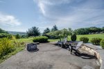 Firepit and Adirondack chairs to relax beside the pond