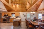 Open kitchen and dining space with patio doors to the deck