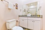 Connected bathroom with double vanity and walk-in shower.