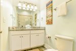 Connected bathroom with double vanity and walk-in shower.