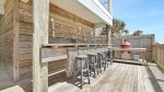 Ground level deck with bar seating and charcoal grill