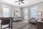 Common area has comfy seating, high-top table and chairs, and a flat screen TV.