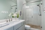 Connected bathroom with spacious walk-in shower.