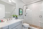 Connected bathroom with walk-in shower.