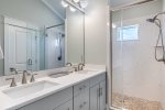 Master bathroom with double vanity and walk-in shower. 