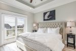 Second King master suite with flat screen TV, en-suite, & direct balcony access.