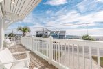 Third floor terrace with lounge seating and gulf views.