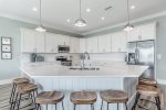 Spacious kitchen with stainless steel appliances and bar seating for 7.