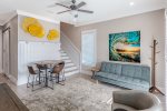 Common area has comfy seating, round table with chairs, and a flat screen TV.