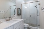 Connected bathroom with walk-in shower.