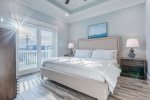 King master suite with flat screen TV, en-suite, & direct balcony access.