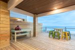 Lower deck area with BBQ grill and seating.