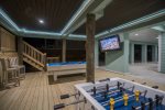 Outside deck area with foosball table, pool table, and flat screen TV
