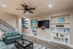 Entryway and living area on 1st floor with flat screen TV.