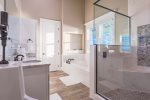 Master bathroom with jetted tub, double vanity, and large walk-in shower.