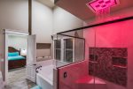 Luxurious master bathroom featuring various colorful lights