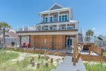 Beautiful beach walk over leads you to and from the home. 