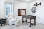Walk in to one-of-a-kind game area with a classic board game on the wall