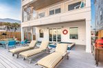 1st floor pool deck with grill and outdoor seating