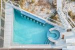 Overhead of pool. Sit on 1 of 8 barstools built in the pool.