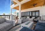 2nd floor furnished balcony overlooking the beach with dining and lounge area