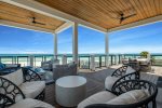 2nd floor furnished balcony overlooking the beach with dining and lounge area