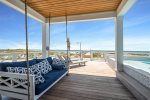 Poolside bed swing, lounge chairs, outdoor shower and private boardwalk